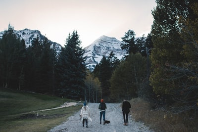 Three people walk on the path of landscape photography
